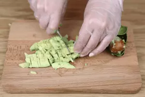 Авокадо нарезать мелко или размять вилкой в пюре.