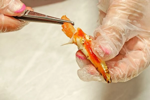 Из клешней краба  вынуть мясо. Удобнее это сделать пинцетом.