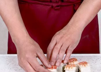 На лист нори выложите рис, оставляя небольшой нахлест.