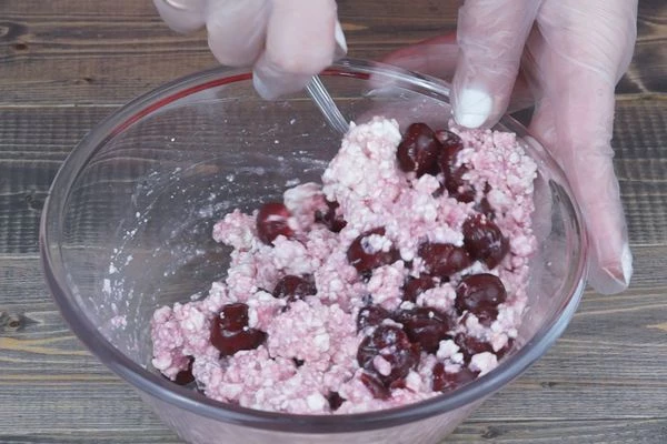 Творожная начинка: вишню разморозить, слить лишнюю жидкость. В чашке смешать творог, вишню, сахар и яйцо. Дать постоять. Если выделится еще жидкость, то слить. Можно загустить крахмалом, тогда начинка будет плотная после приготовления.