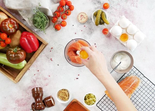 В чашу блендера выложить филе и желток. Посолить.