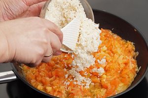 К обжаренным овощам добавьте промытый рис, кукурузную муку,  потушите 5-7 минут.