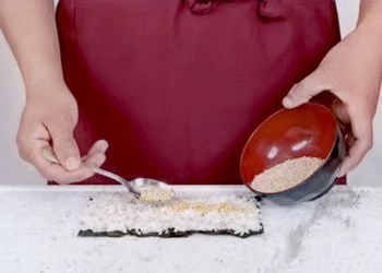 На лист нори выложите рис, оставляя небольшой нахлест.