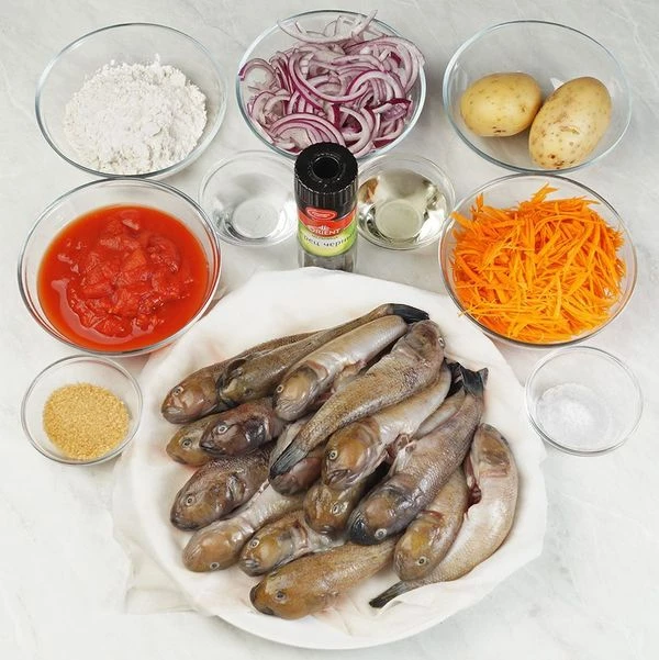 Бычки разморозить естественным образом на нижней полке холодильника. Очистить от чешуи, срезать плавники, разрезать вдоль брюшка, удалить внутренности. Хорошо промыть под проточной холодной водой. Морковь и лук нарезать тонкой соломкой.