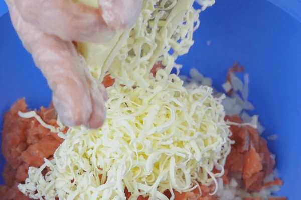 В фарш натереть на крупной терке подмороженное сливочное масло.