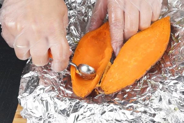 Готовый батат разрезать на 2 половинки. Пока теплый, вынуть мякоть, оставляя по краям по 0,5-1см в виде "лодочки". 