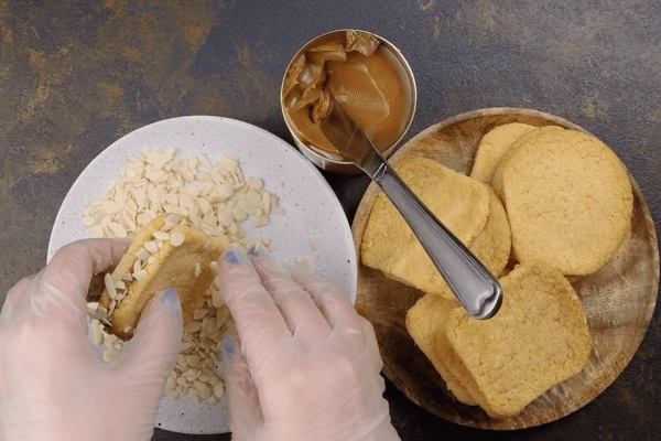 По краям обвалять в лепестках ореха (можно взять кокосовую стружку).