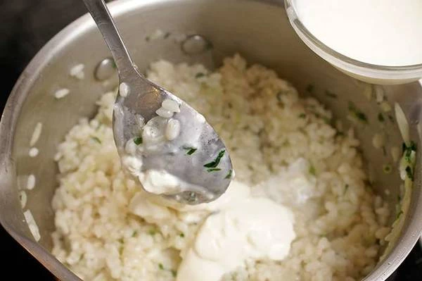 Добавить к луку и чесноку основу для ризотто, бульон, сливки, готовить постоянно помешивая. Консистенция должна быть кремообразная.