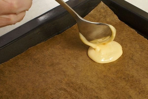 На застеленный пергаментом противень распределить тонким слоем тесто в виде кружков, диаметром примерно 4-5 см.