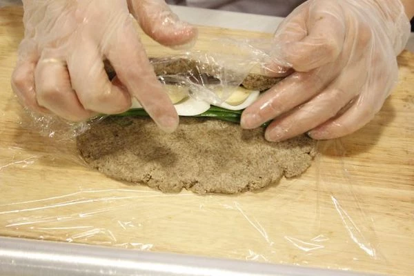 С помощью пленки заверните массу с начинкой в "ролл". Закрутите плотно края пленки. Положите в холодильник на 30-40 минут.