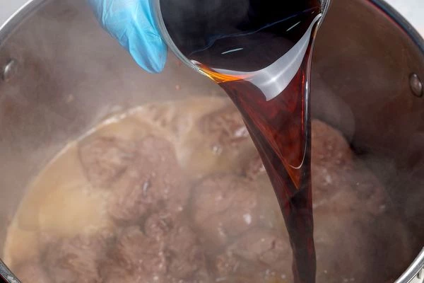 Влить к мясу 1ст горячей воды и вино (гранатовый сок). Потушить примерно 1 час.