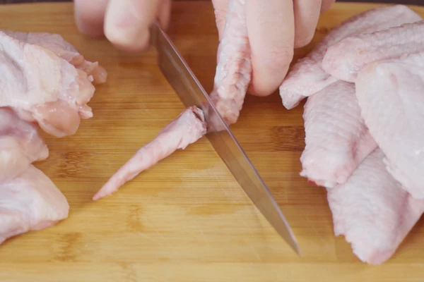Куриные крылья разморозить, промыть, обсушить салфеткой, удалить последнюю фалангу. 
