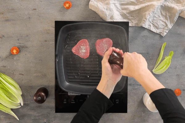 Тунец разморозить на нижней полке холодильника, обсушить салфеткой. На сковороду гриль налить оливковое масло, выложить тунца, посолить, поперчить, обжарить с каждой стороны по 2 минуты. Нарезать на ломтики.
