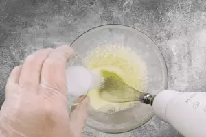 Белок взбить с щепоткой соли до "пиков".