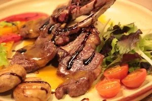 Выложить в центр тарелки башенку из кус куса, горкой баранину. Рядом овощи. Полить соусом.