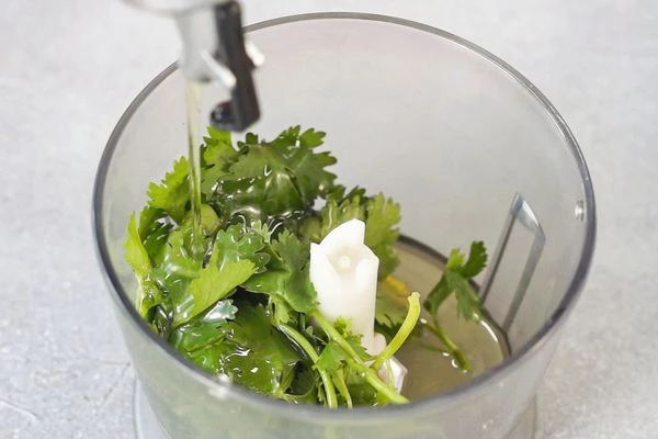 В блендере выложить кинзу, чеснок, соль, налить масло. Измельчить.
