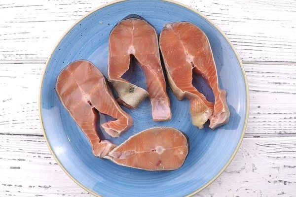 Стейки разморозить естественным способом на нижней полке холодильника, промыть под проточной водой, обсушить бумажным полотенцем.