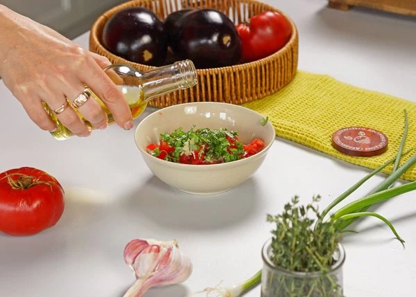 Томаты вымыть, нарезать мелким кубиком. Добавить натертый чеснок и измельченный базилик, посолить, влить половину оливкового масла, перемешать.